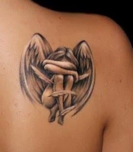 Realisti small girl's angel tattoo on shoulder