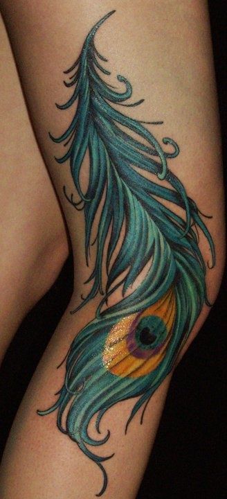 Realistic look peacock tattoo on leg