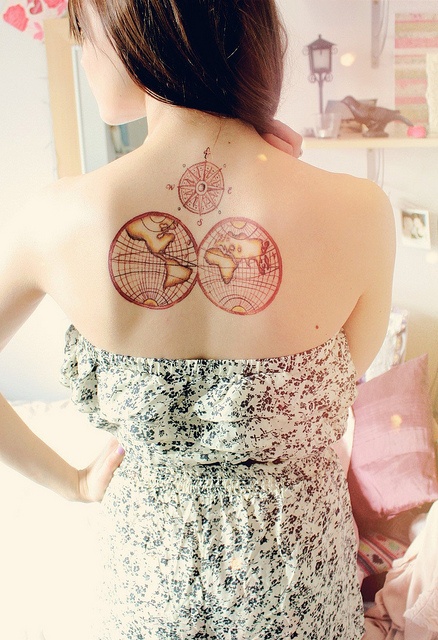 Red adorable compass tattoo on back