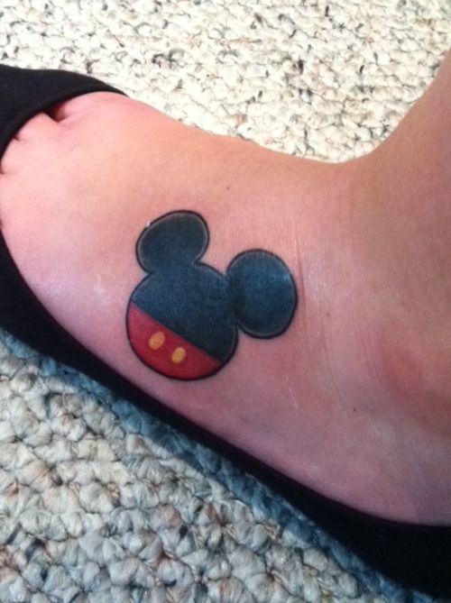 Red and black Mickey Mouse tattoo on leg