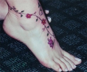 Red flowers girl tattoo on foot