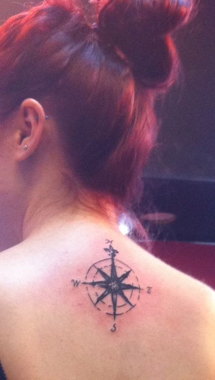 Red hair girl compass tattoo on back