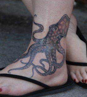 Red nails and octopus tattoo on leg