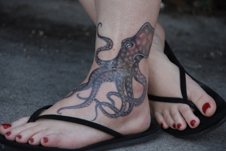 Red nails and octopus tattoo on leg