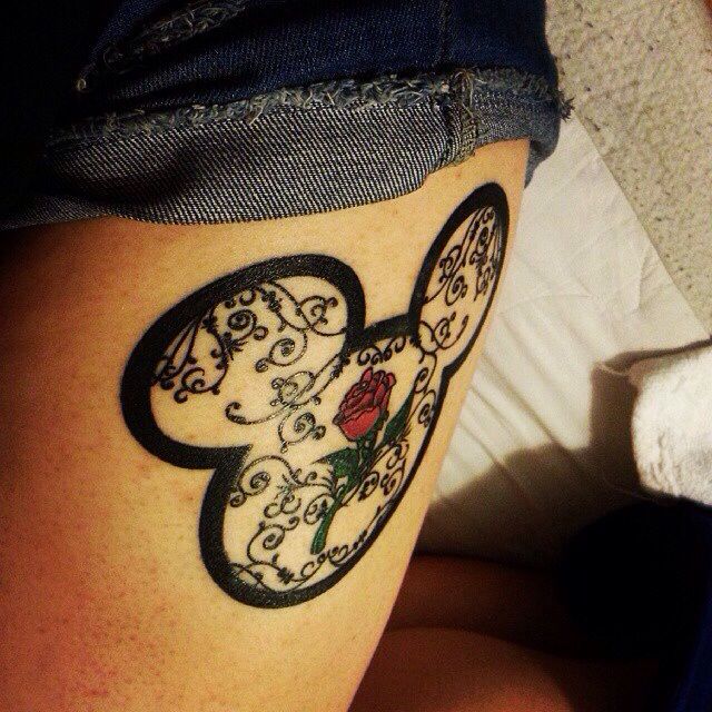 Red rose with ornaments Mickey Mouse tattoo on arm