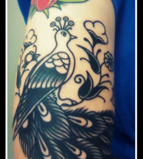Red tulips and black peacock tattoo on leg