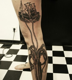 Ship black octopus tattoo on leg
