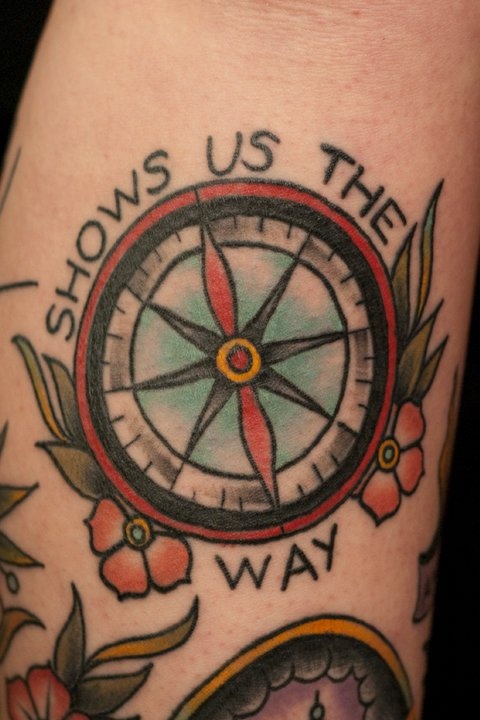Shows us the compass tattoo on leg