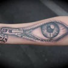 Skull, eye and zip tattoo
