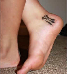 Small heart girl tattoo on foot