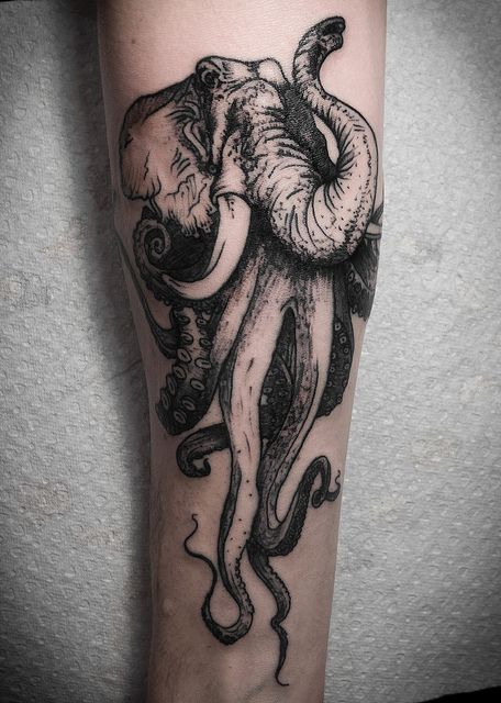 Strange elephant and octopus tattoo on arm