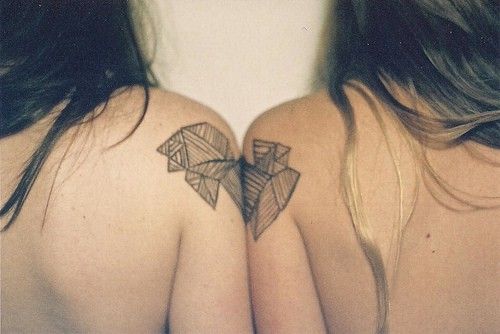 Two women’s geometric shoulder, back tattoo