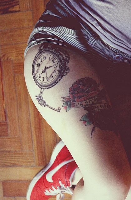 Watch and simple compass tattoo on leg