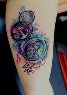 Watercolor anchor and compass tattoo on arm
