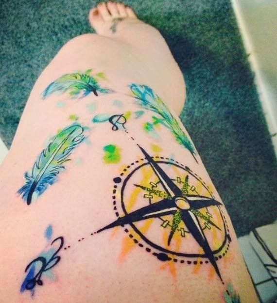 Compass tattoos on legs
