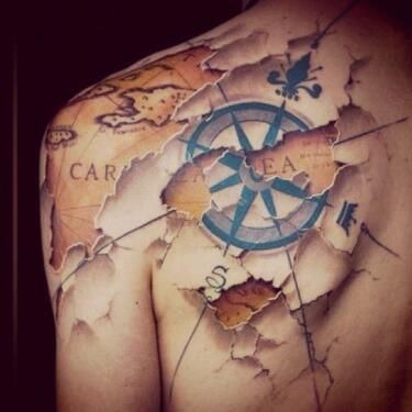 Black compass tattoo on back