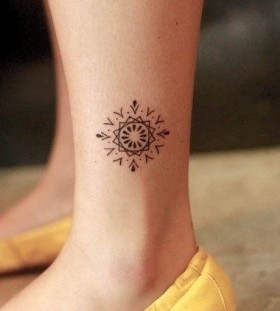 Yellow shoes and geometric tattoo on leg
