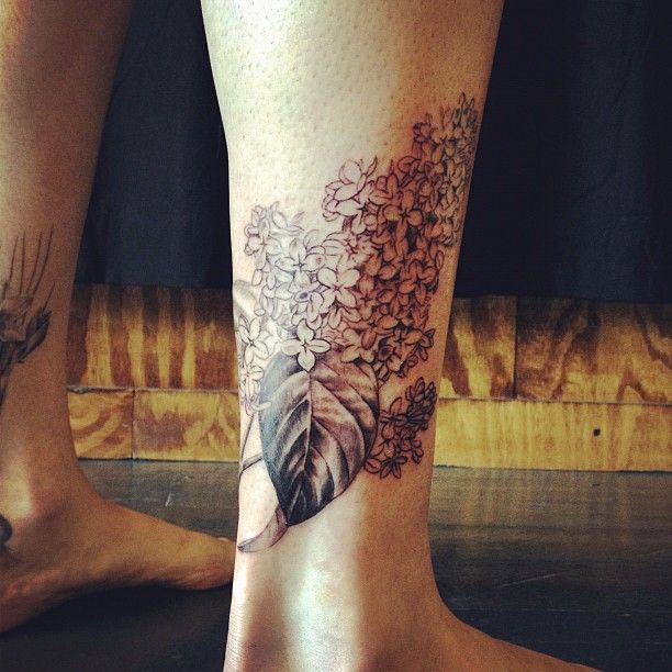 black and white lilac tattoo on leg