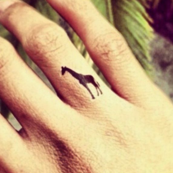 black giraffe tattoo on finger