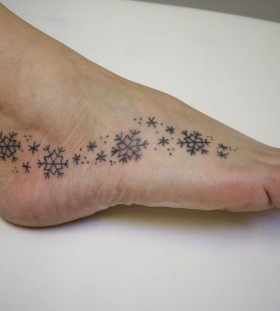 black snowflake tattoo on foot