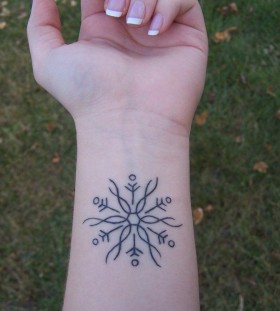 black snowflake tattoo on wrist