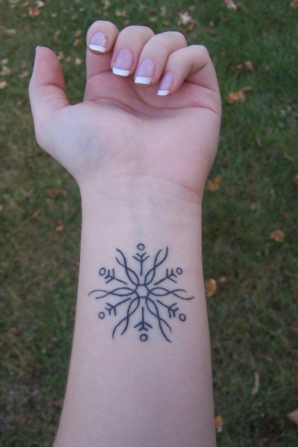 black snowflake tattoo on wrist