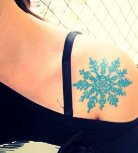 blue snowflake tattoo on shoulder