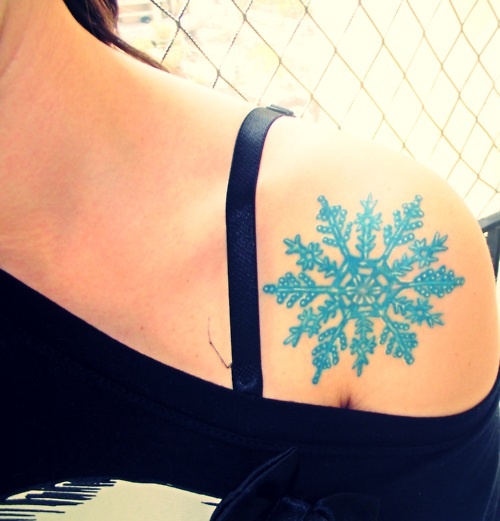 blue snowflake tattoo on shoulder