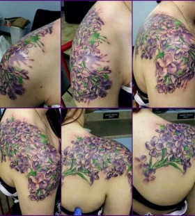 large lilac tattoo on the back and shoulder
