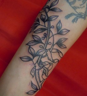 leaves with bird tattoo