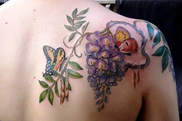 lilac with butterfly tattoo on the shoulder and back