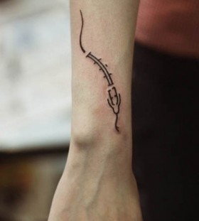 small snake tattoo on arm