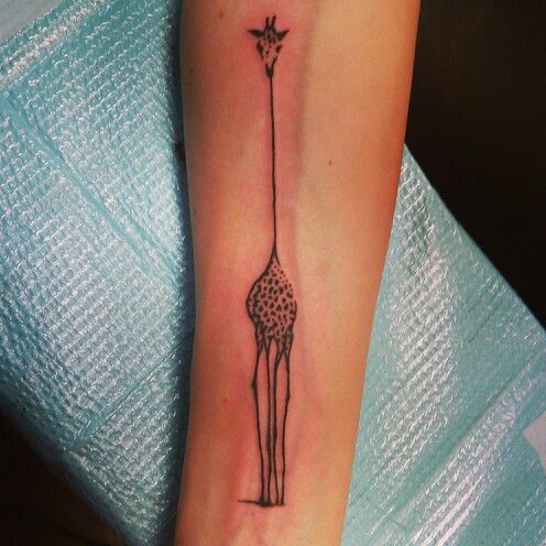 thin giraffe tattoo on arm