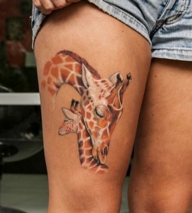 two multicolor giraffes tattoo on thigh