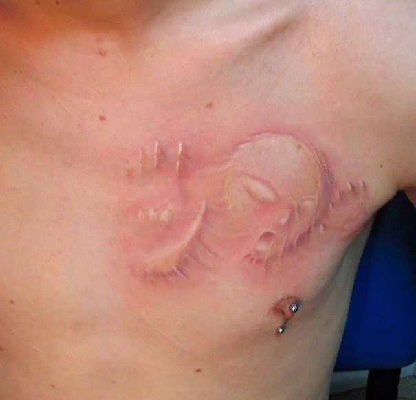 3D person trying to get out of chest tattoo