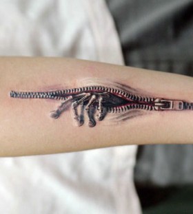 3D zipper effect with skeleton hand on arm tattoo