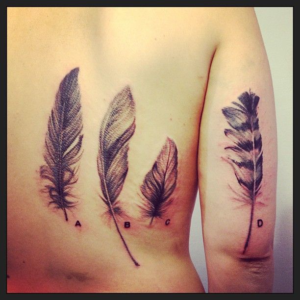 4 feathers back and arm tattoos
