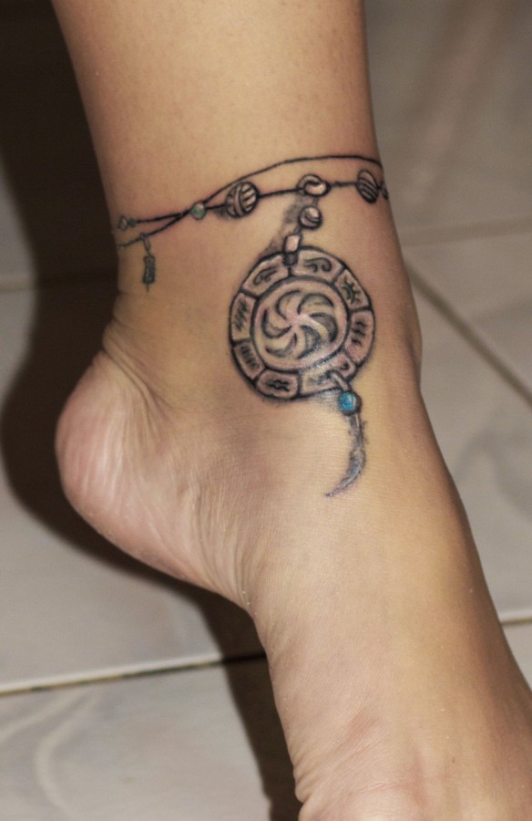 Ancient symbol ankle tattoo