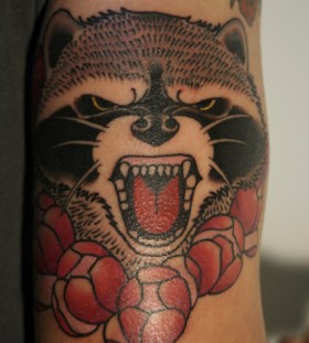 Angry raccoon arm tattoo