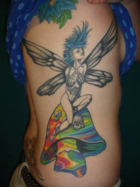 Awesome fairy and colourful mushroom tattoo