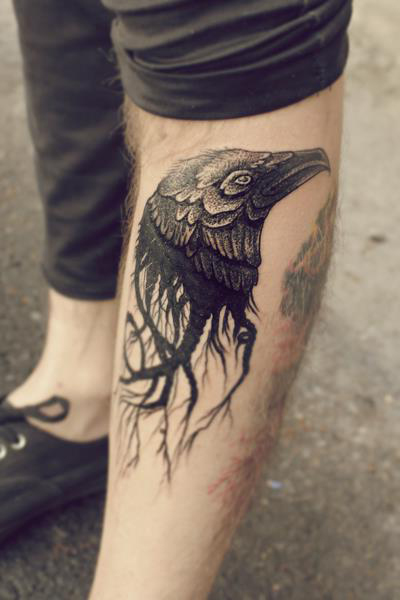 Awesome raven’s head leg tattoo