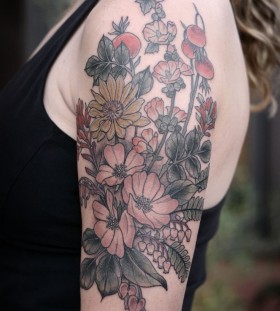 Beautiful flowers arm tattoo by Kirsten Holliday
