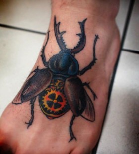Beetle tattoo on foot by Charley Gerardin