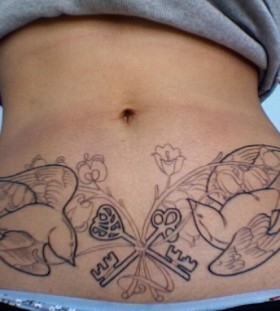 Birds and keys stomach tattoo