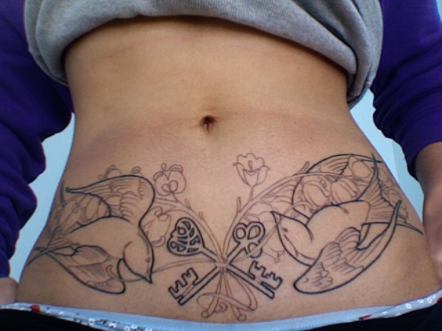 Birds and keys stomach tattoo