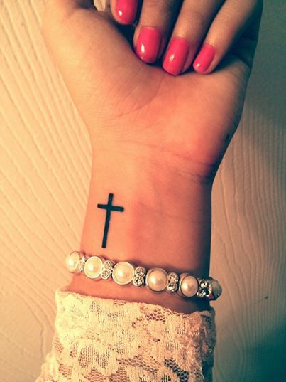 Black cross wrist tattoo
