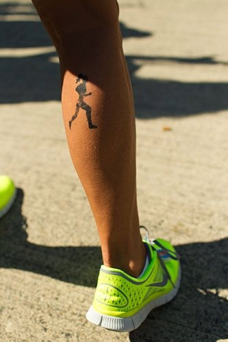 Black girl’s leg’s sport tattoo