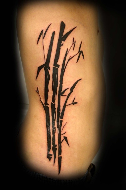 Black ink bamboo tree side tattoo