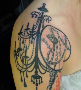 Black ink chandelier shoulder tattoo