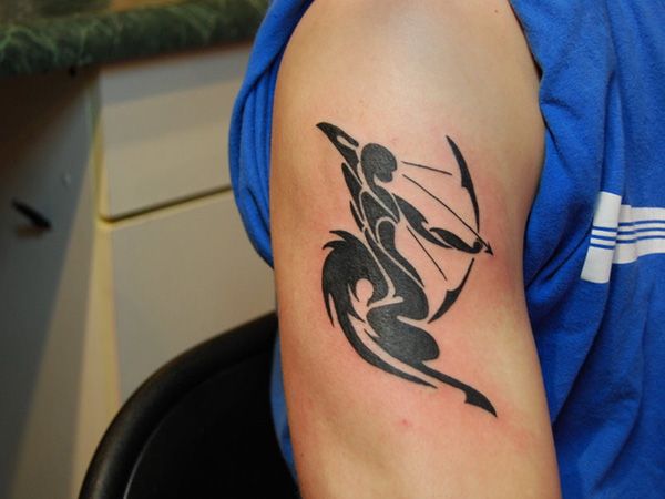 Black ink sagittarius arm tattoo